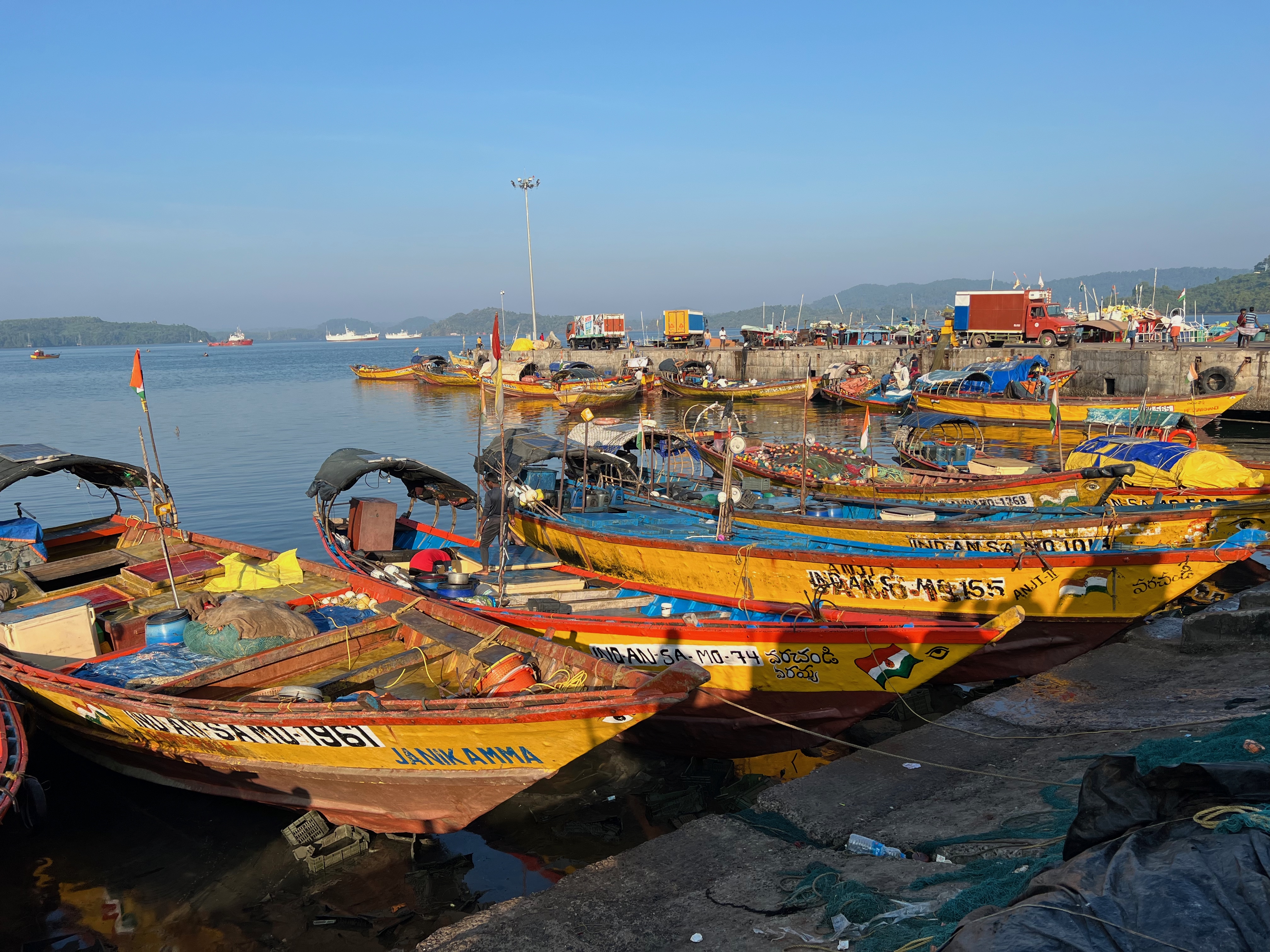 Yellow fishing boats docked in a row. 